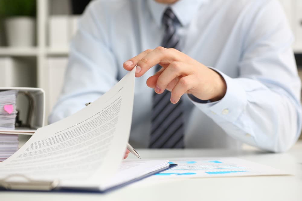 A professional reviews legal documents at a desk, symbolizing the thorough approach of truck accident lawyer.