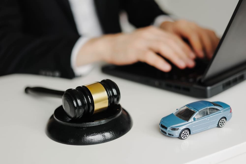 Chula Vista car accident lawyers reviewing crash case with gavel and model car