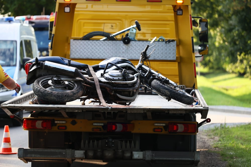 Motorcycle loaded onto a tow truck after a traffic accident