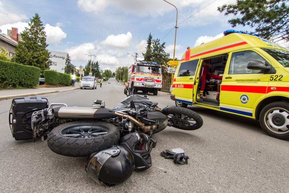 Motorcycle crash scene with emergency vehicles responding on a wide roadway in Chula Vista