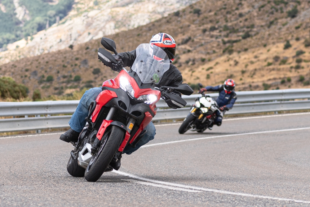 Motorcyclists riding through a curve where drivers making left turns may fail to see approaching motorcycles