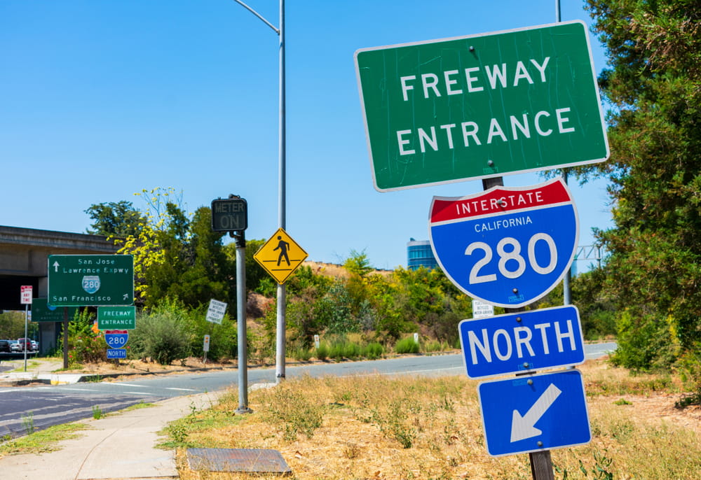 California Interstate 280 freeway entrance sign near pedestrian crossing and on-ramp area