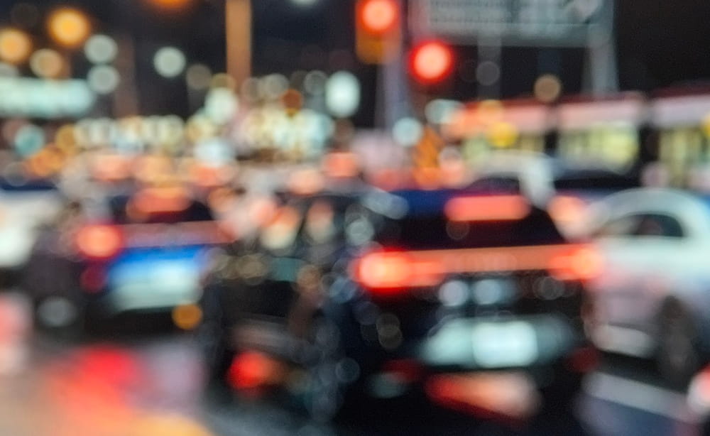Blurred nighttime traffic illustrating limited driver visibility in low-light conditions